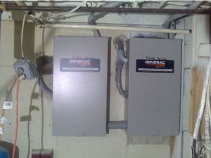 Two, wall-mounted Generac electric panels are installed adjacent to each other.